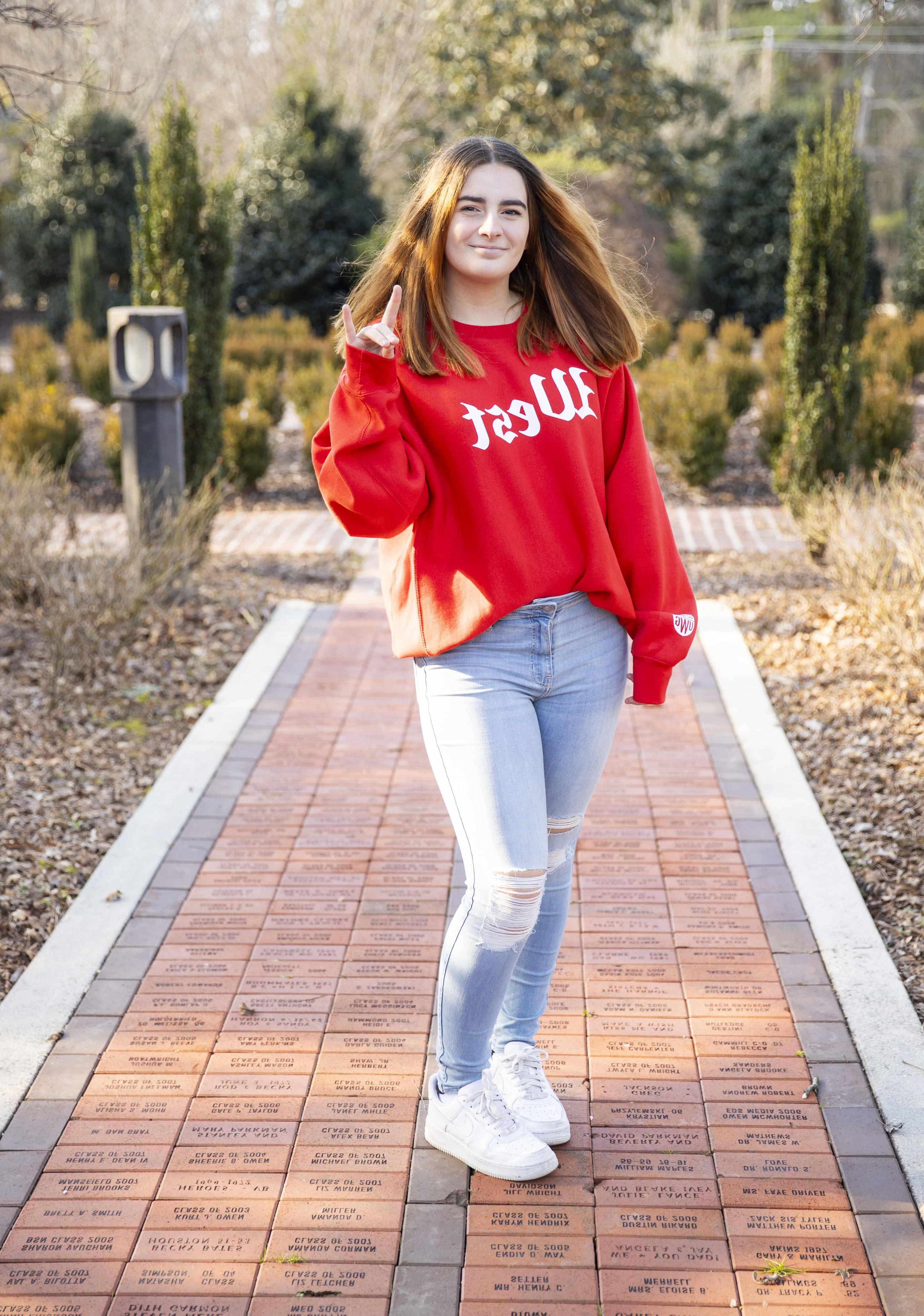 Ilona Kish posing for an outside portait in the alumni garden.